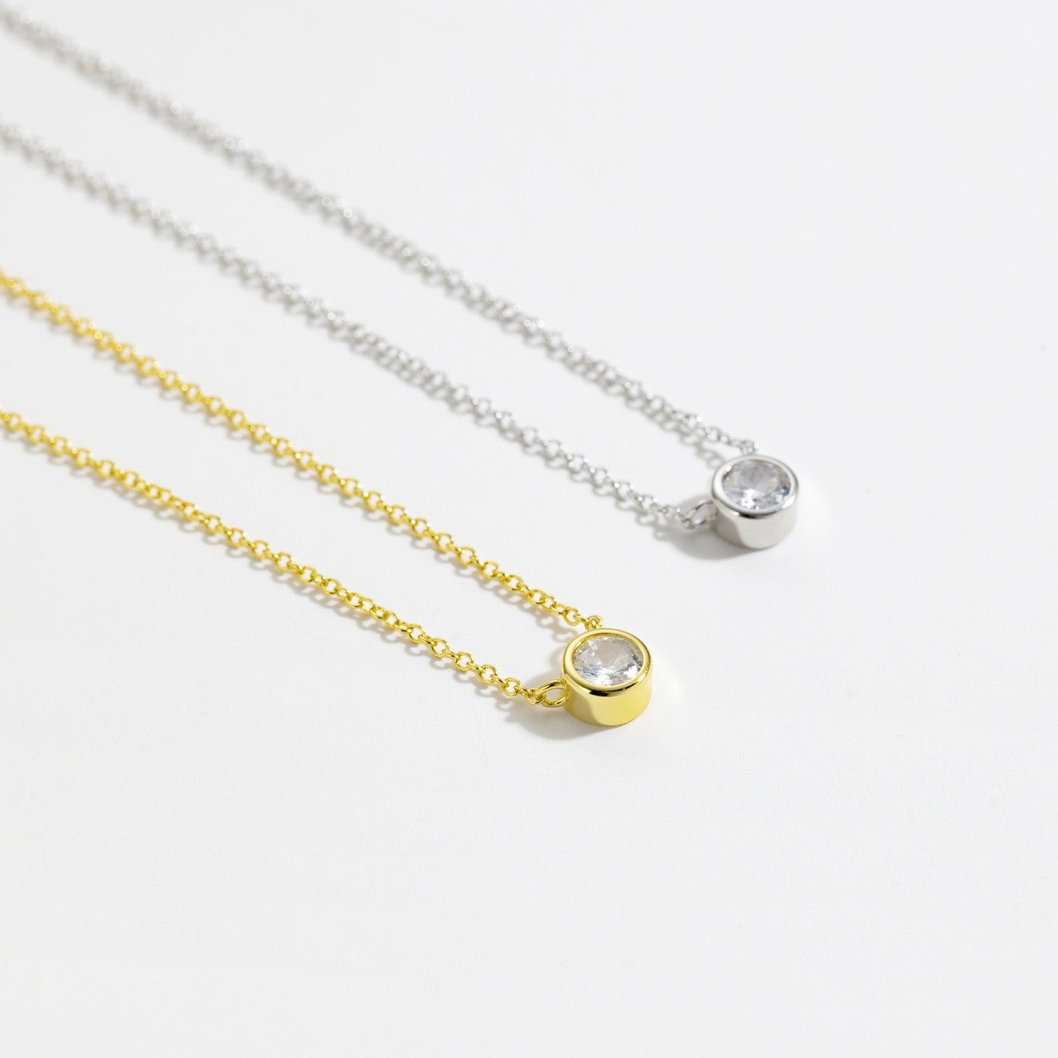 Gold and silver bezel-set solitaire cz necklace comparison
