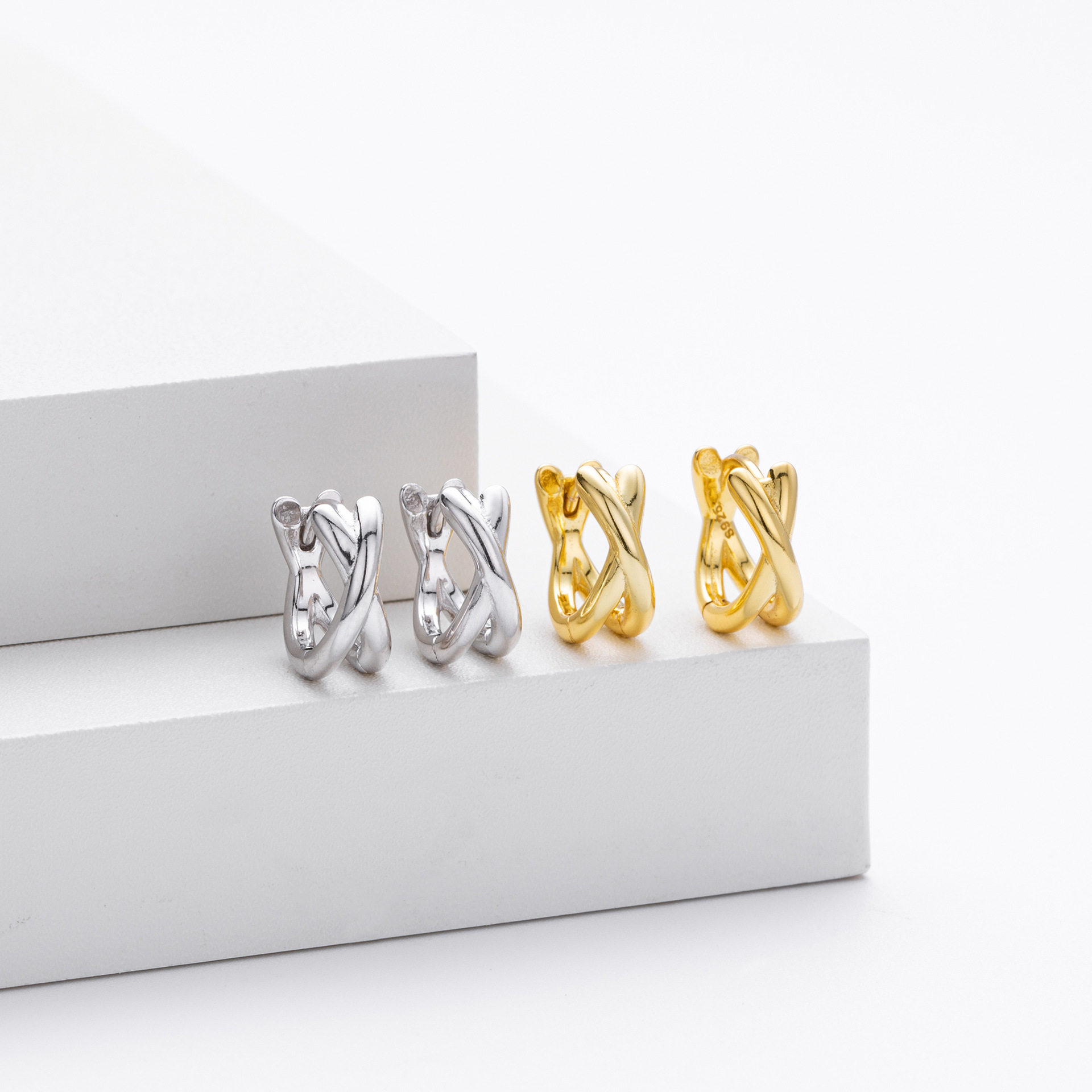 Gold and silver crisscross twisted huggie hoop earrings collection