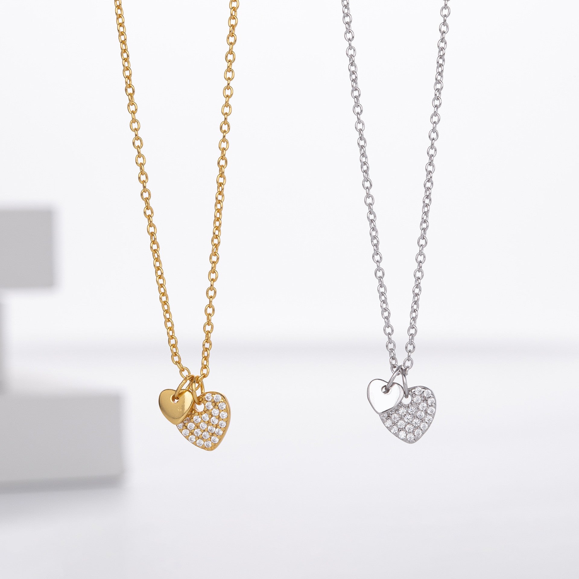 Gold and silver dual heart pave cz necklace comparison