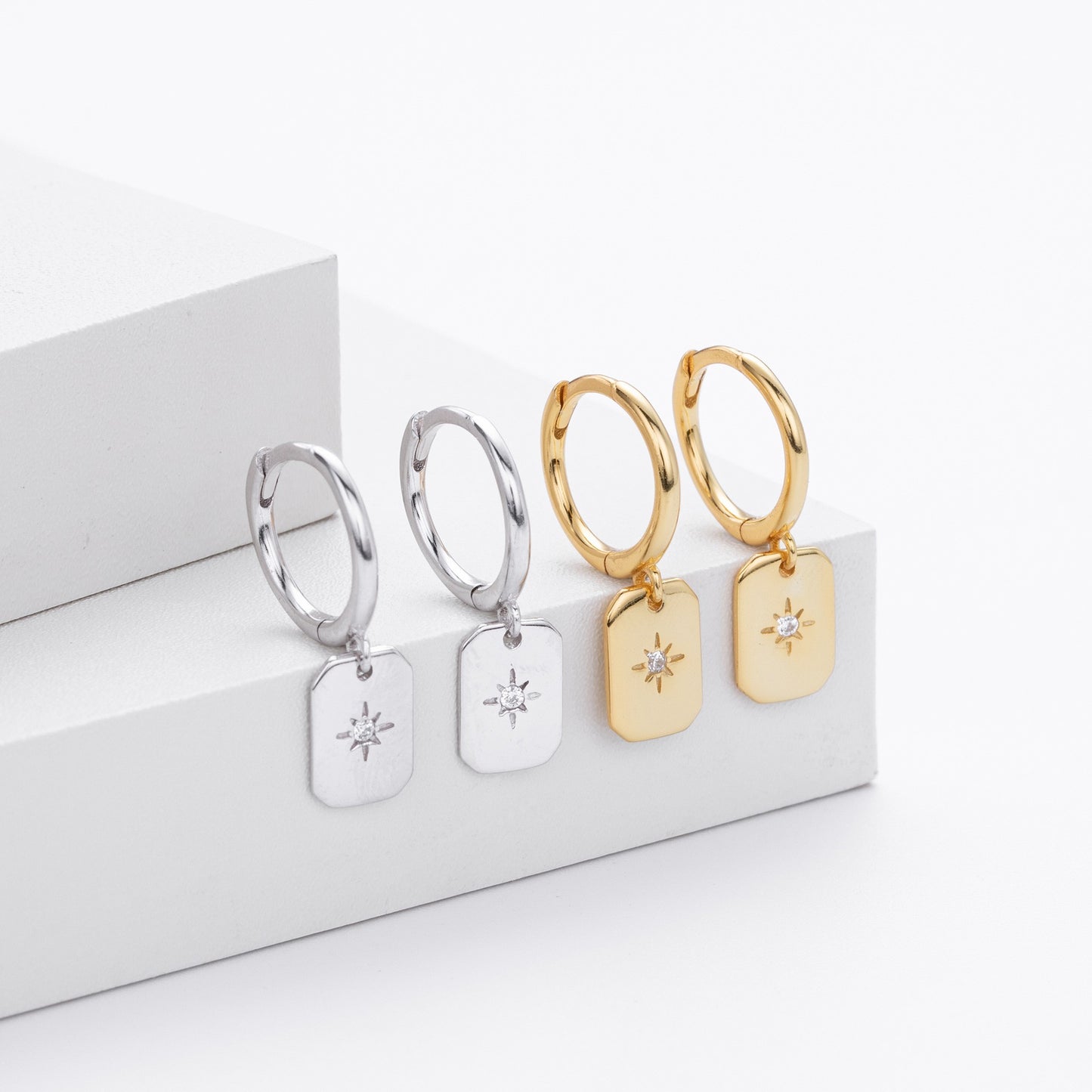 Gold and silver starburst tag drop hoop earrings collection