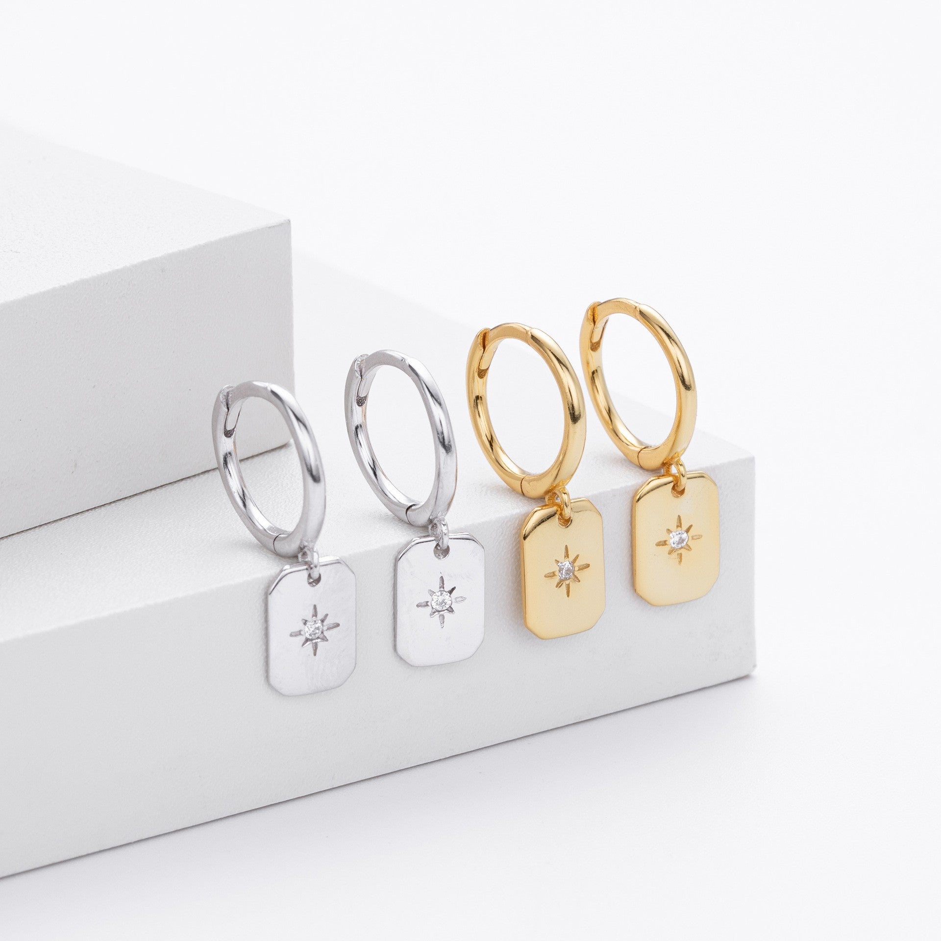Gold and silver starburst tag drop hoop earrings collection