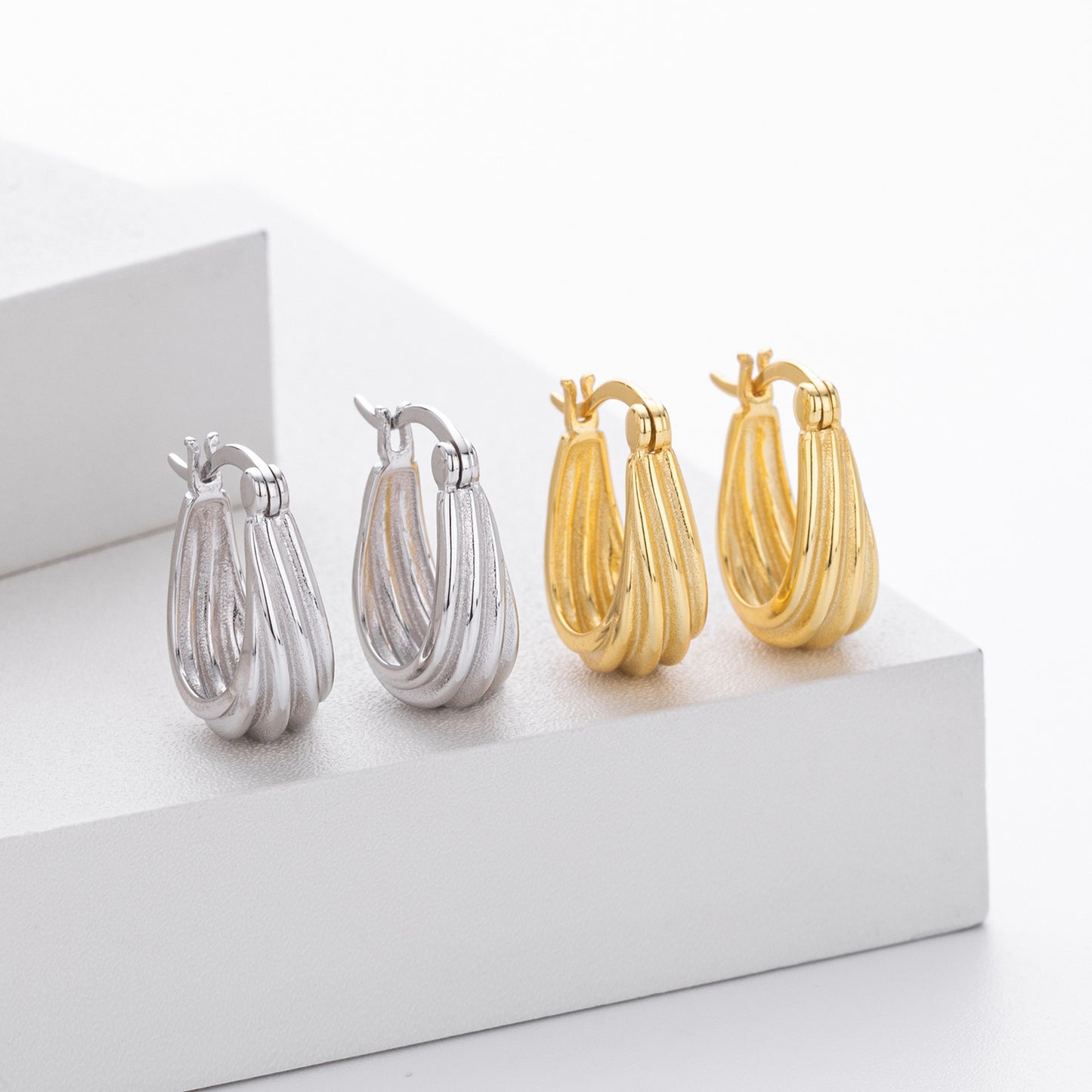 Gold and silver twisted ribbed huggie hoop earrings collection