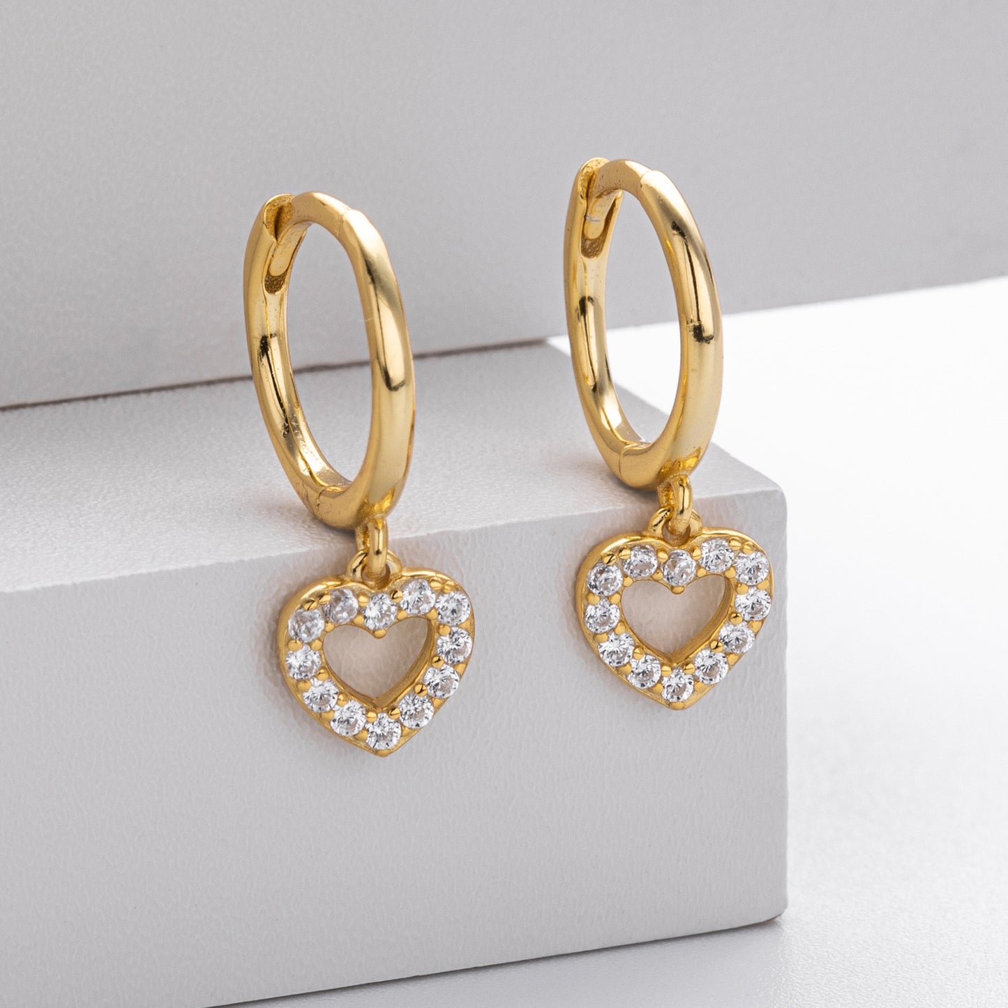 Gold plated hollow heart cz drop hoop earrings close-up