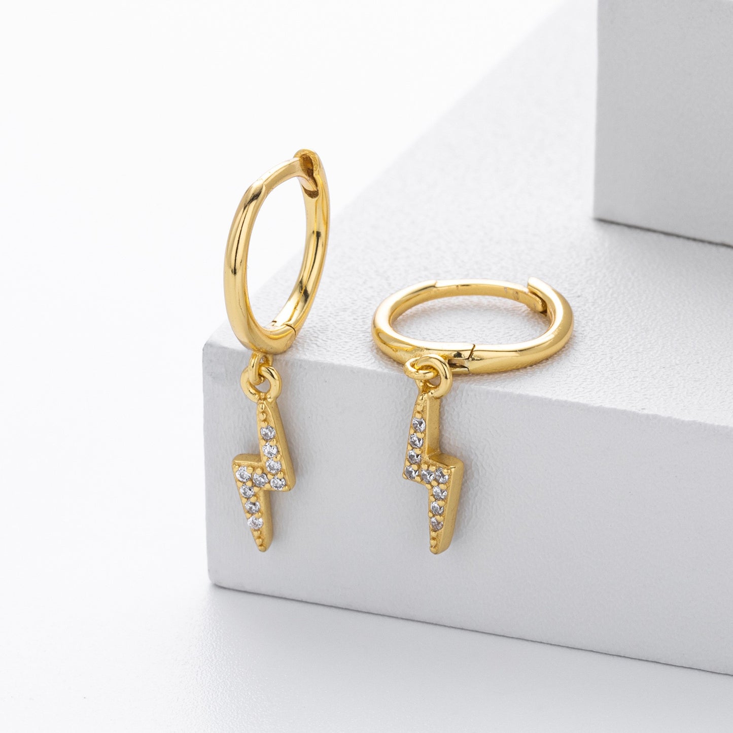 Gold plated lightning bolt cz drop hoop earrings close-up
