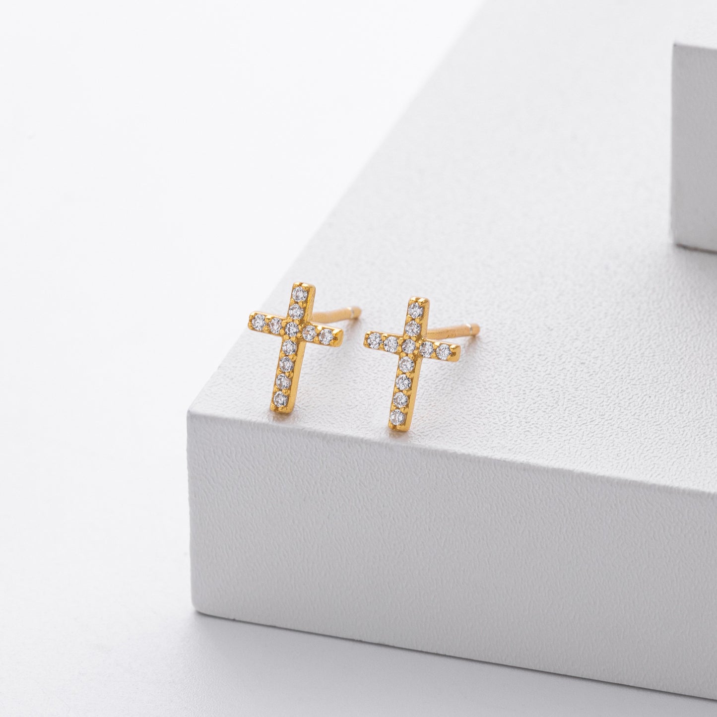 Gold plated pave cross stud earrings close-up