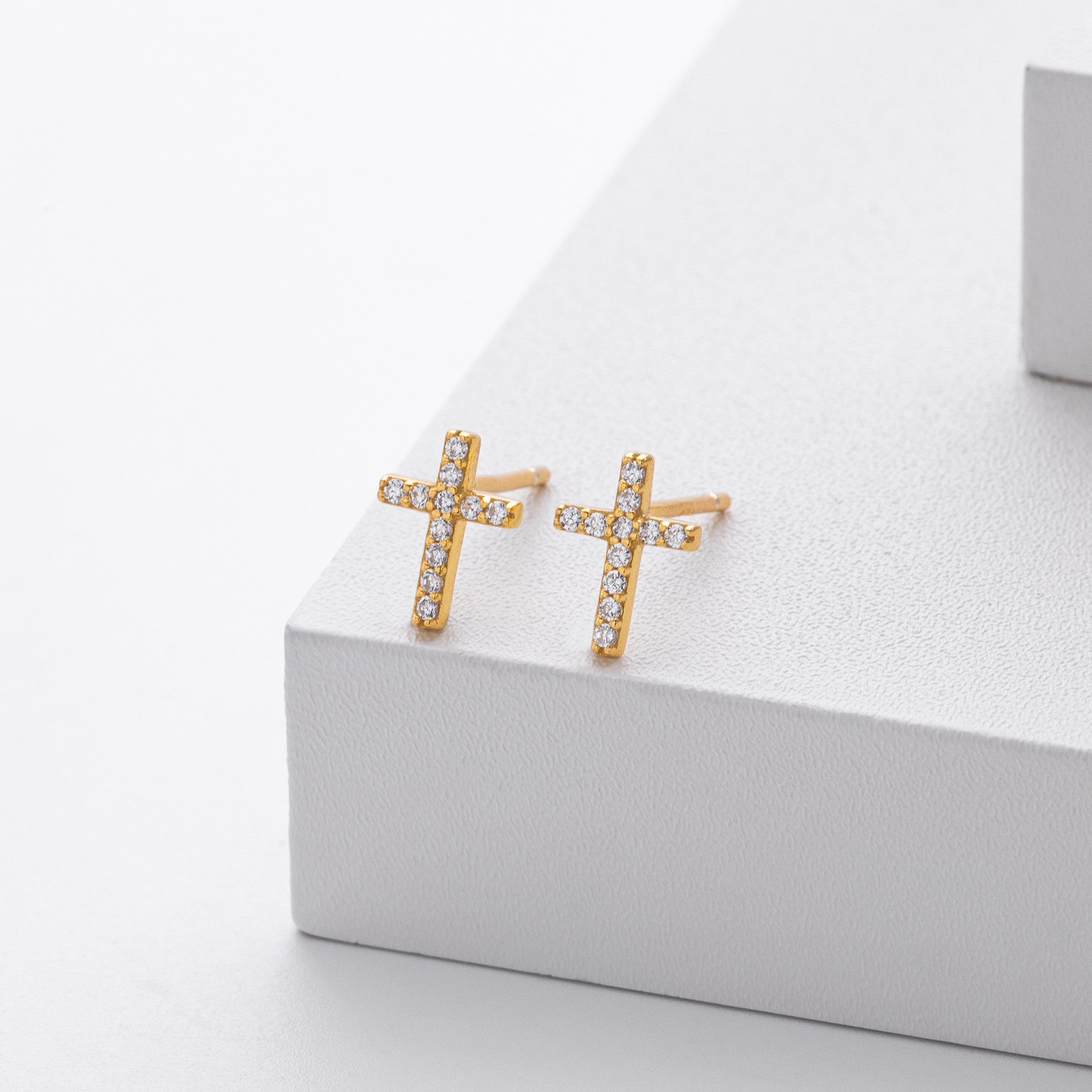 Gold plated pave cross stud earrings close-up