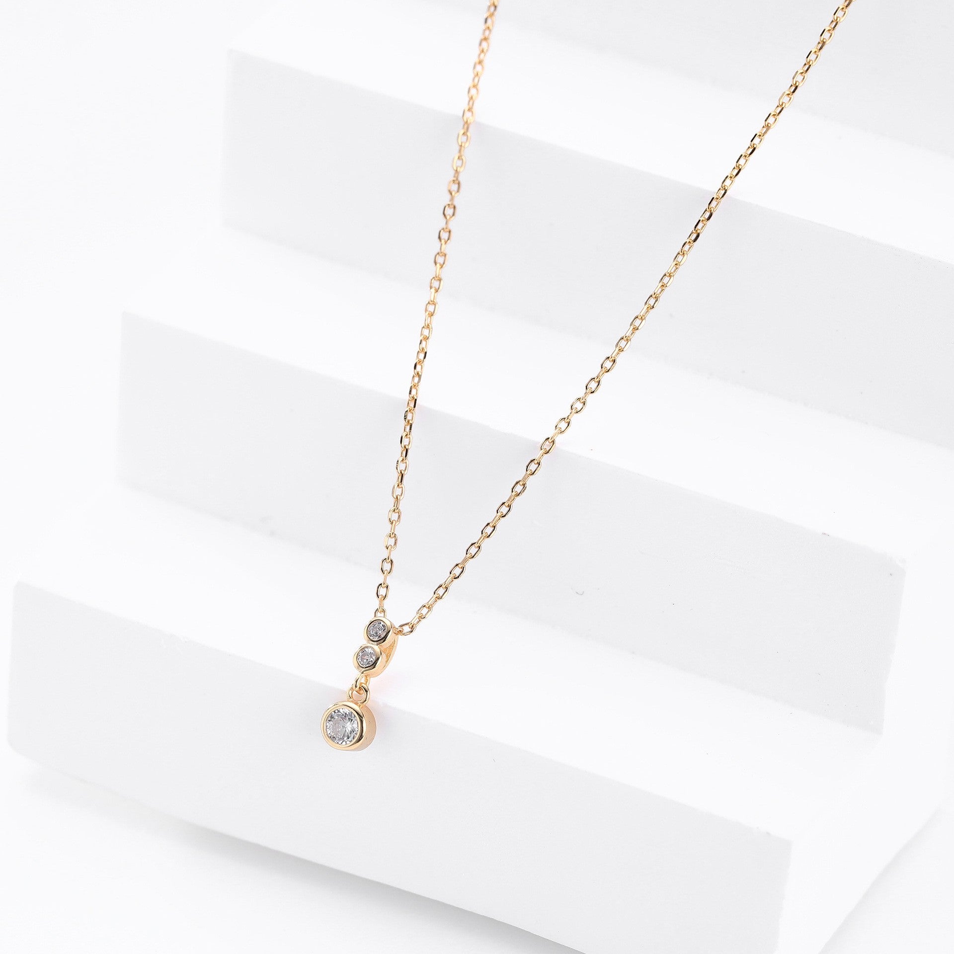 Gold plated three-tiered round cz drop necklace - side view