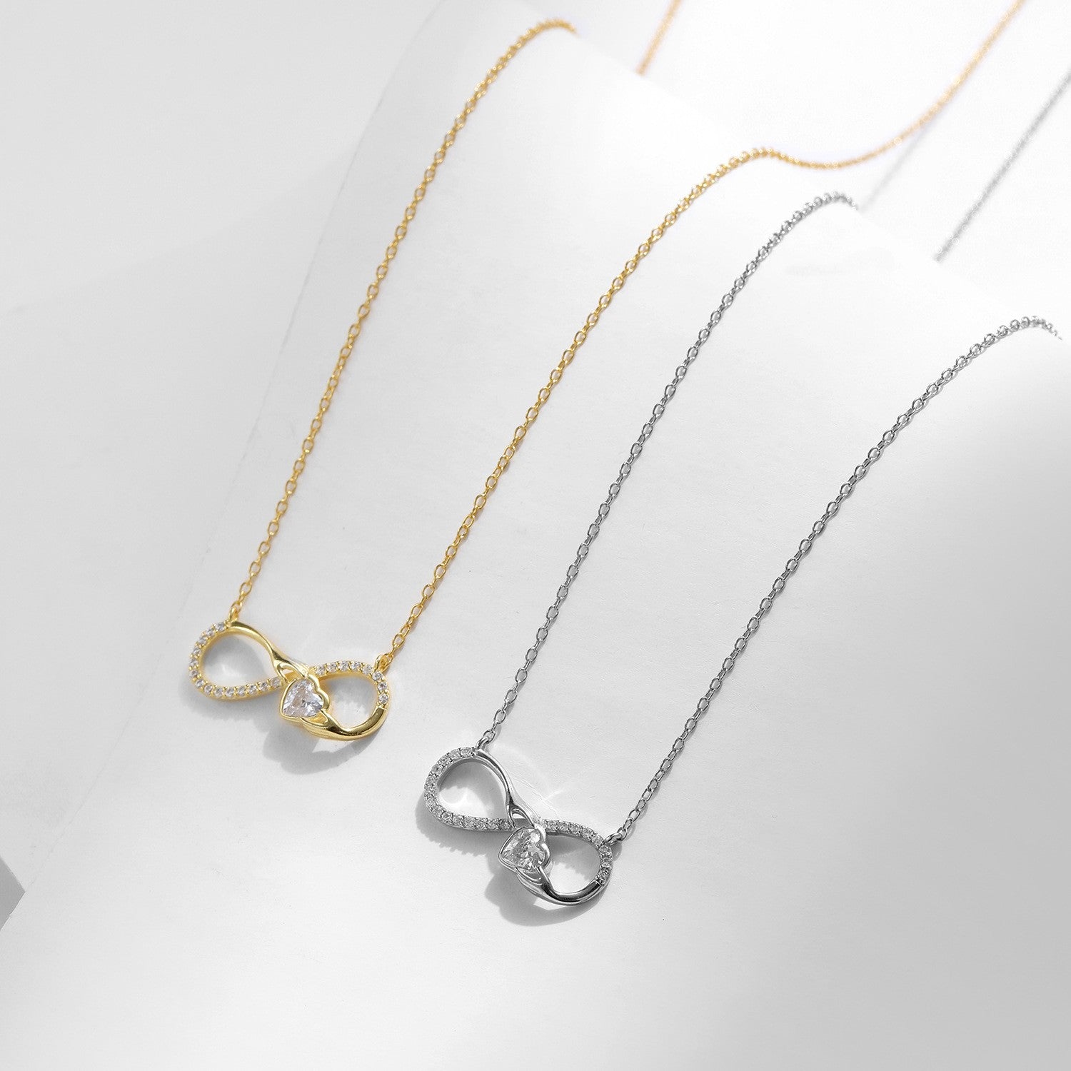 Gold and silver infinity cz necklace comparison