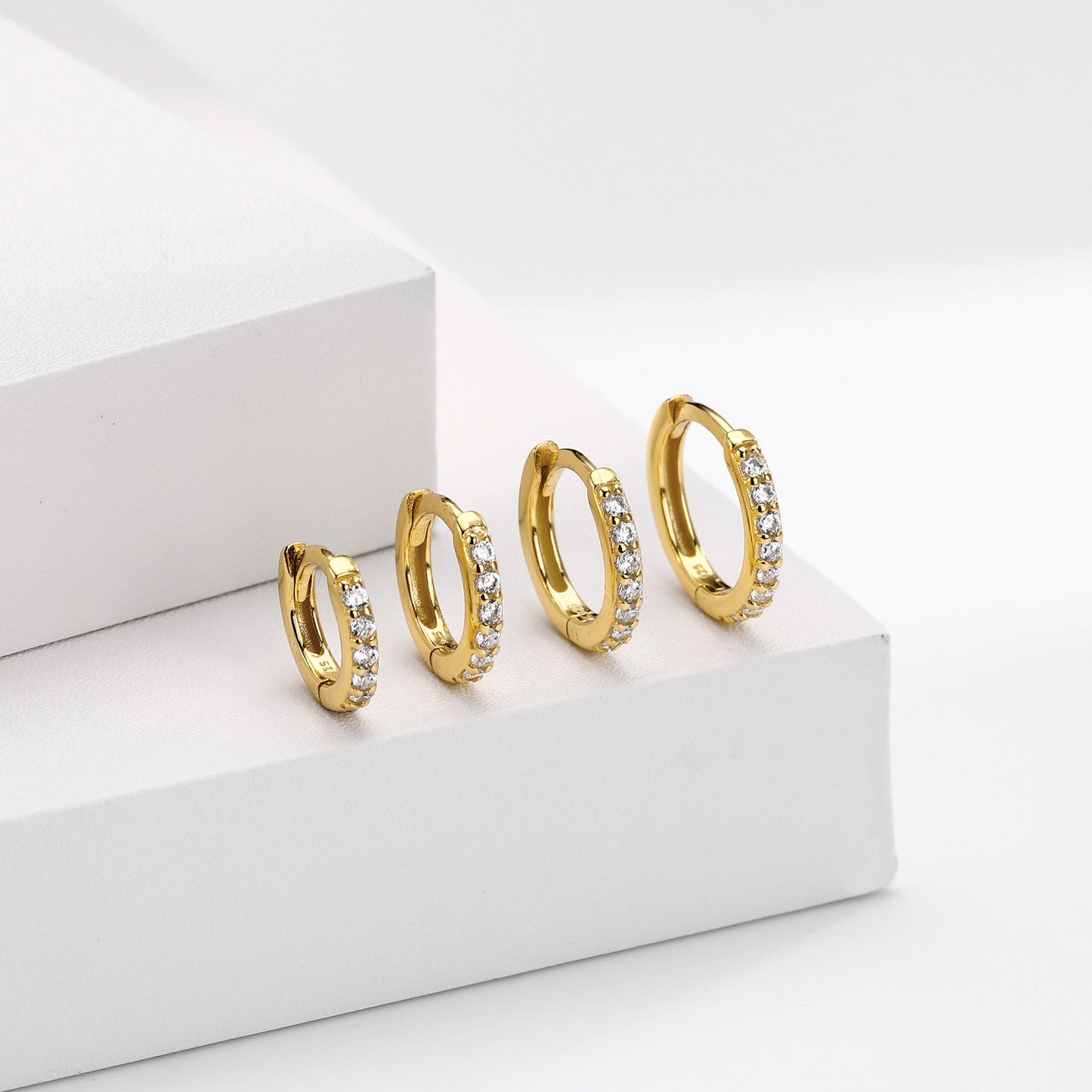 Different sizes of gold plated cz huggie hoop earrings