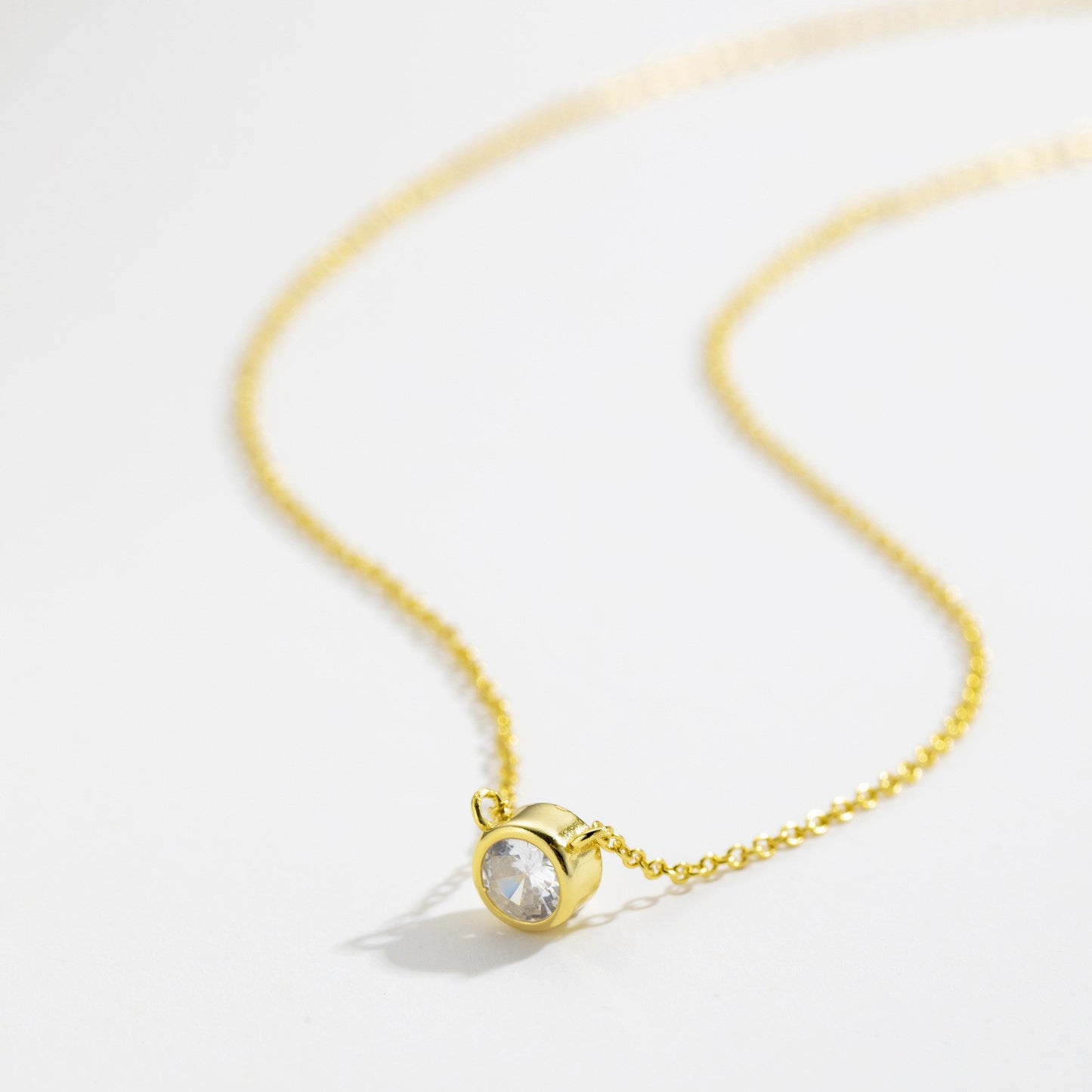 Gold plated bezel-set solitaire cz necklace close-up