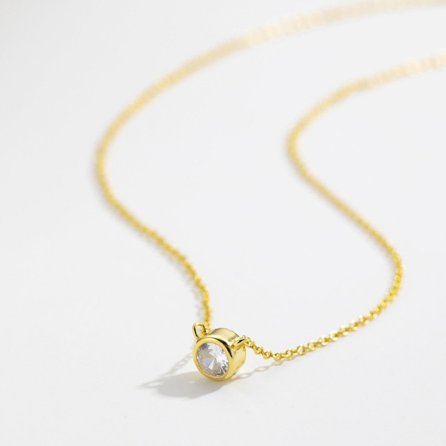Gold plated bezel-set solitaire cz necklace close-up