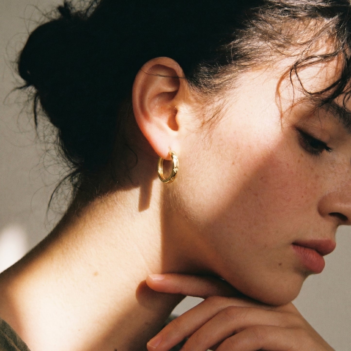 Starburst cz huggie hoop earrings - worn on ear