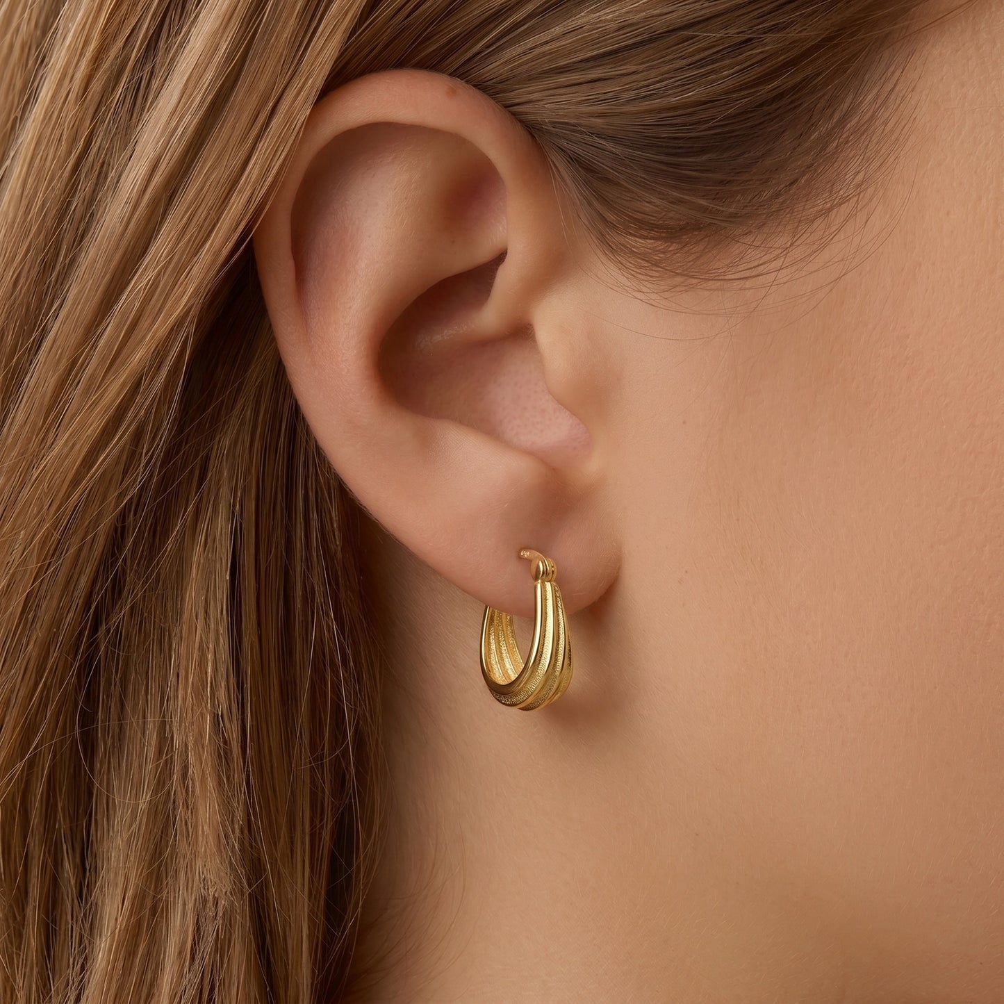 Twisted ribbed huggie hoop earrings - worn on ear